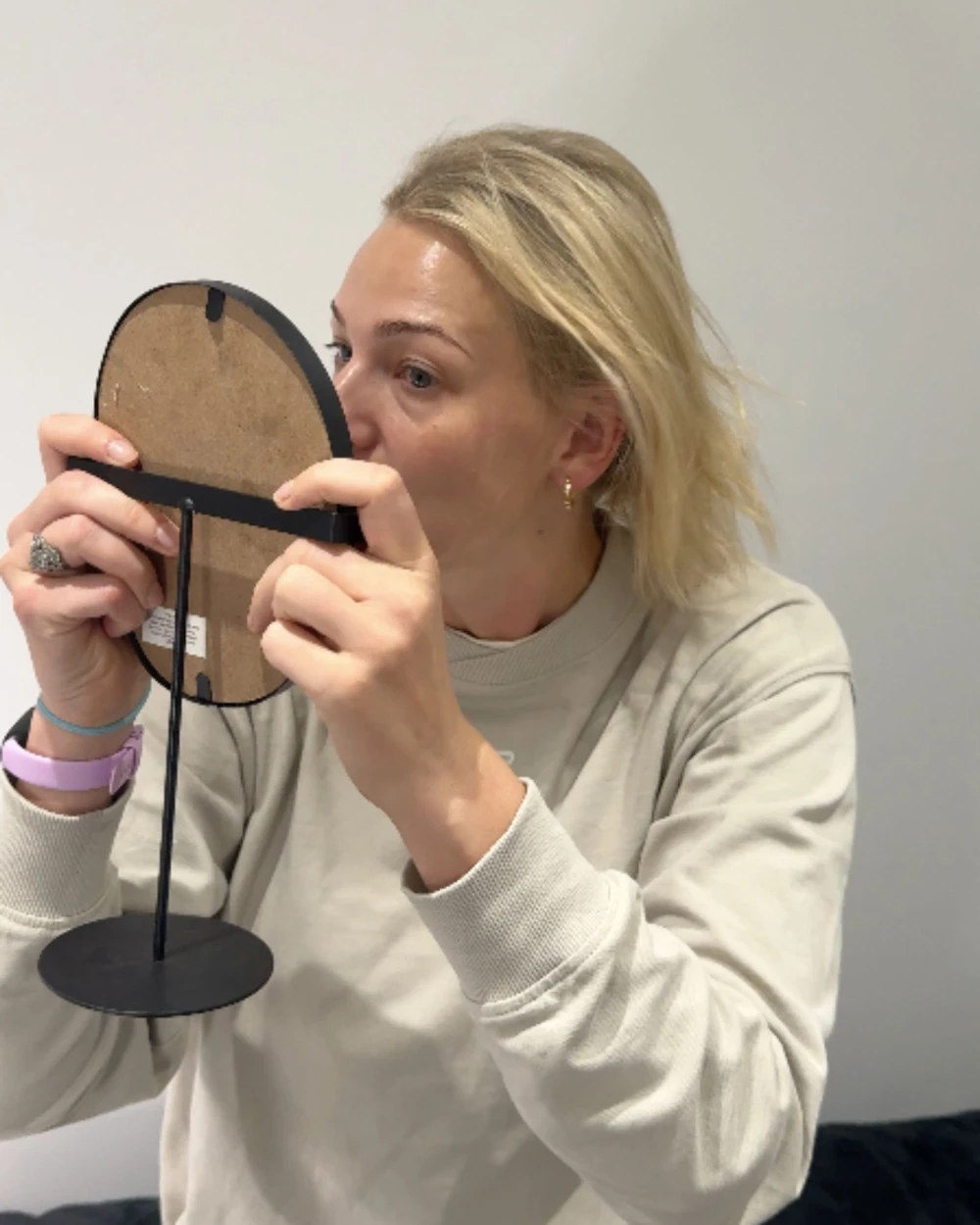 A patient seeing her result in the mirror, captured on a shoot day